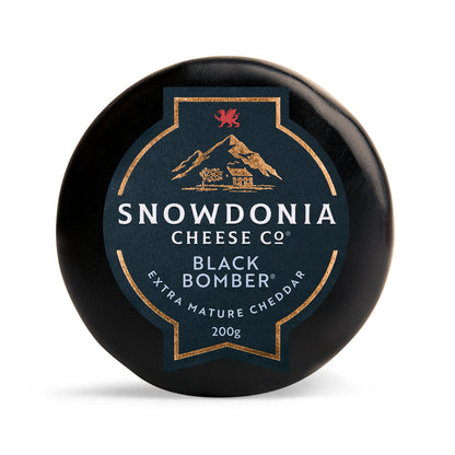 Snowdonia Cheese Company Black Bomber waxed cheese truckle on a white background